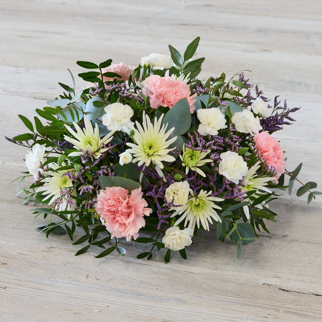 Rose Garden Tribute with abundant white roses and palm leaves